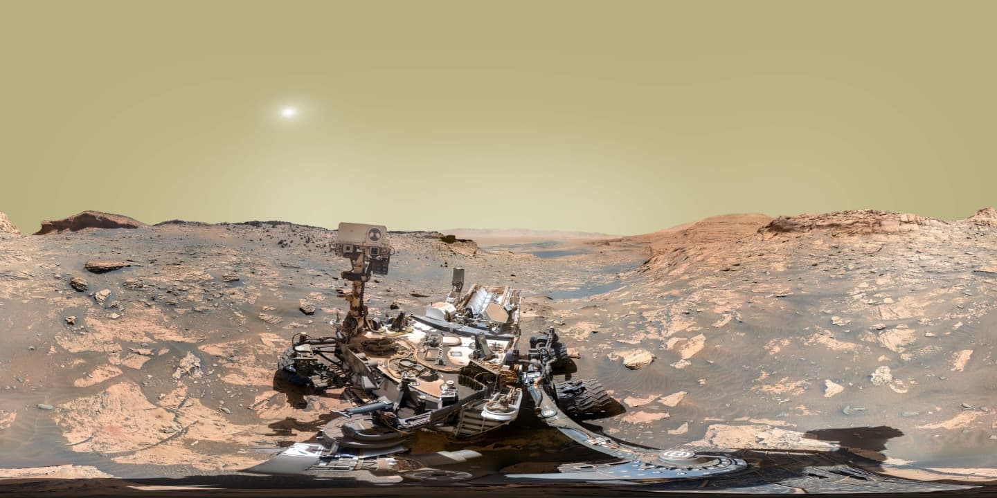 NASA's Curiosity Mars rover took this 360-degree selfie using the Mars Hand Lens Imager, or MAHLI, at the end of its robotic arm. The selfie comprises 81 individual images taken on Nov. 20, 2021 – the 3,303rd Martian day, or sol, of the mission. The rock structure behind the rover is 'Greenheugh Pediment'; the hill that is middle distance on the right, is 'Rafael Navarro Mountain'. Curiosity is headed toward 'Maria Gordon Notch', the U-shaped opening behind the rover to the left. Curiosity was built by NASA's Jet Propulsion Laboratory in Southern California. Caltech in Pasadena, California, manages JPL for NASA. JPL manages Curiosity's mission for NASA's Science Mission Directorate in Washington. MAHLI was built by Malin Space Science Systems in San Diego.