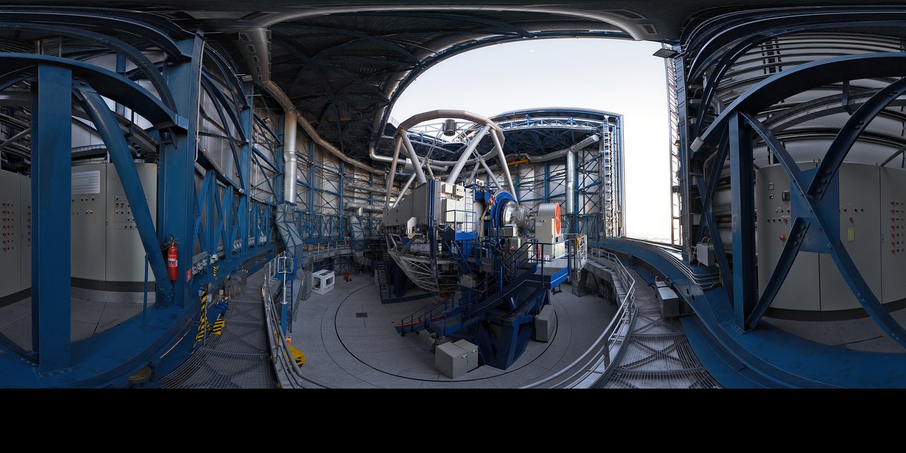 A 360º panorama view taken in 2007 inside the first of the four 8.2-metre Unit Telescopes (UTs) of ESO’s Very Large Telescope (VLT) at Paranal. Designated Unit Telescope 1, or UT1, and named Antu (“the Sun” in the indigenous Mapuche language), this complex science machine has been in operation at Paranal since 1999. Just before sunset, engineers and technicians open the telescopes, finalising the preparation for the night-time observation run. Although it is not obvious in this image due to the panoramic projection, the UTs are housed in compact buildings thanks to their altazimuth mounting and innovative design. Composed of four 8.2-metre UTs and four 1.8-metre mobile Auxiliary Telescopes (ATs), the ESO VLT is the world's most advanced optical ground-based telescope.